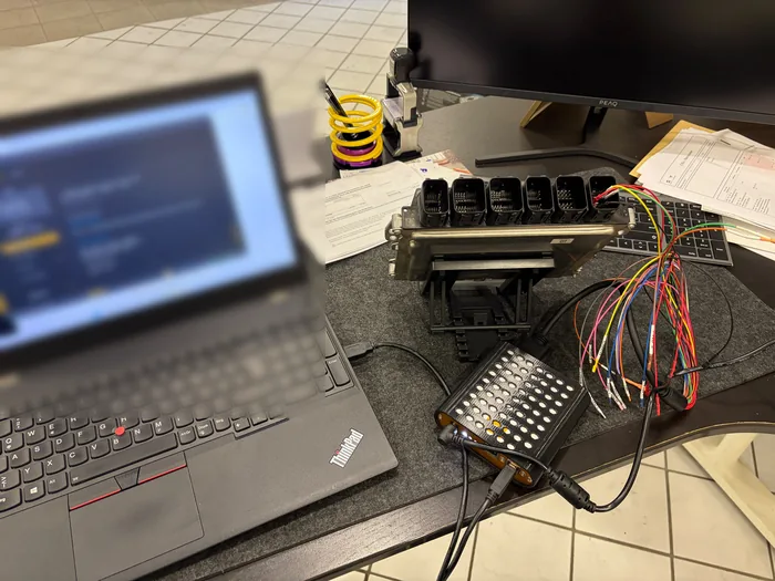 Arbeitsplatz mit Laptop, Steuergerät und angeschlossenem Kabelbaum