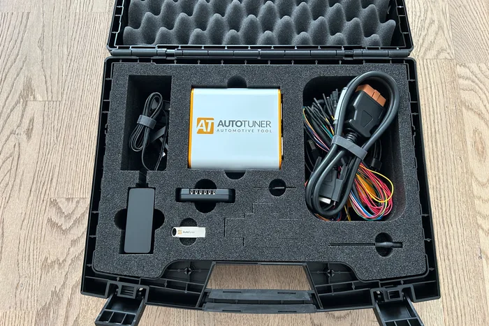 Geöffneter Koffer mit dem AutoTuner-Programmiergerät, Adaptern und Kabelsatz im Schaumstoffeinsatz
