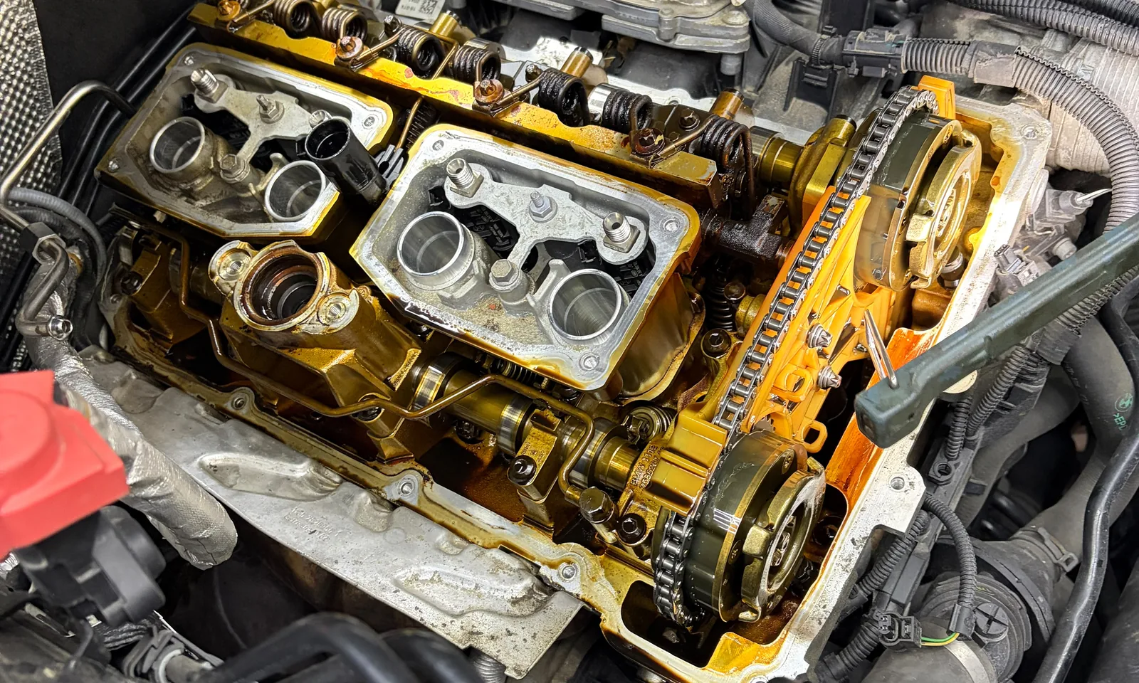 Geöffneter Zylinderkopf mit freiliegenden Nockenwellen und Steuerkette während einer Motorarbeit